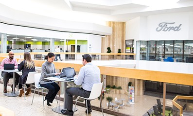 Male and female employees working at Ford in a common area